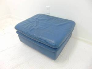 lot 96 image: Genuine Leather Blue Ottoman with Wheels