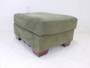lot 472 image: Sage Green Faux Suede Ottoman with Wood Legs by Ashley Furniture