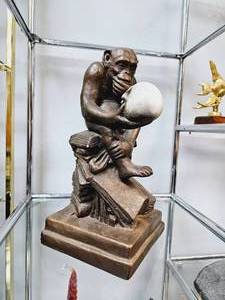 lot 27 image: Vintage Austin Productions Monkey Holding Skull on Darwin Books Sculpture