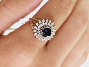 lot 101 image: 14KT White Gold Diamond and Sapphire Ring Size 7 Replacement Value $3,386.00- Appraisal Certificate Included