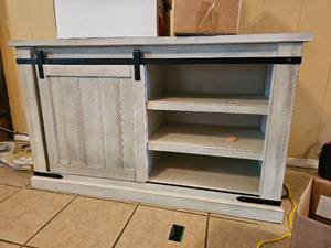 lot 182 image: Farmhouse Style Sliding Front Door TV Stand by Ashley Furniture